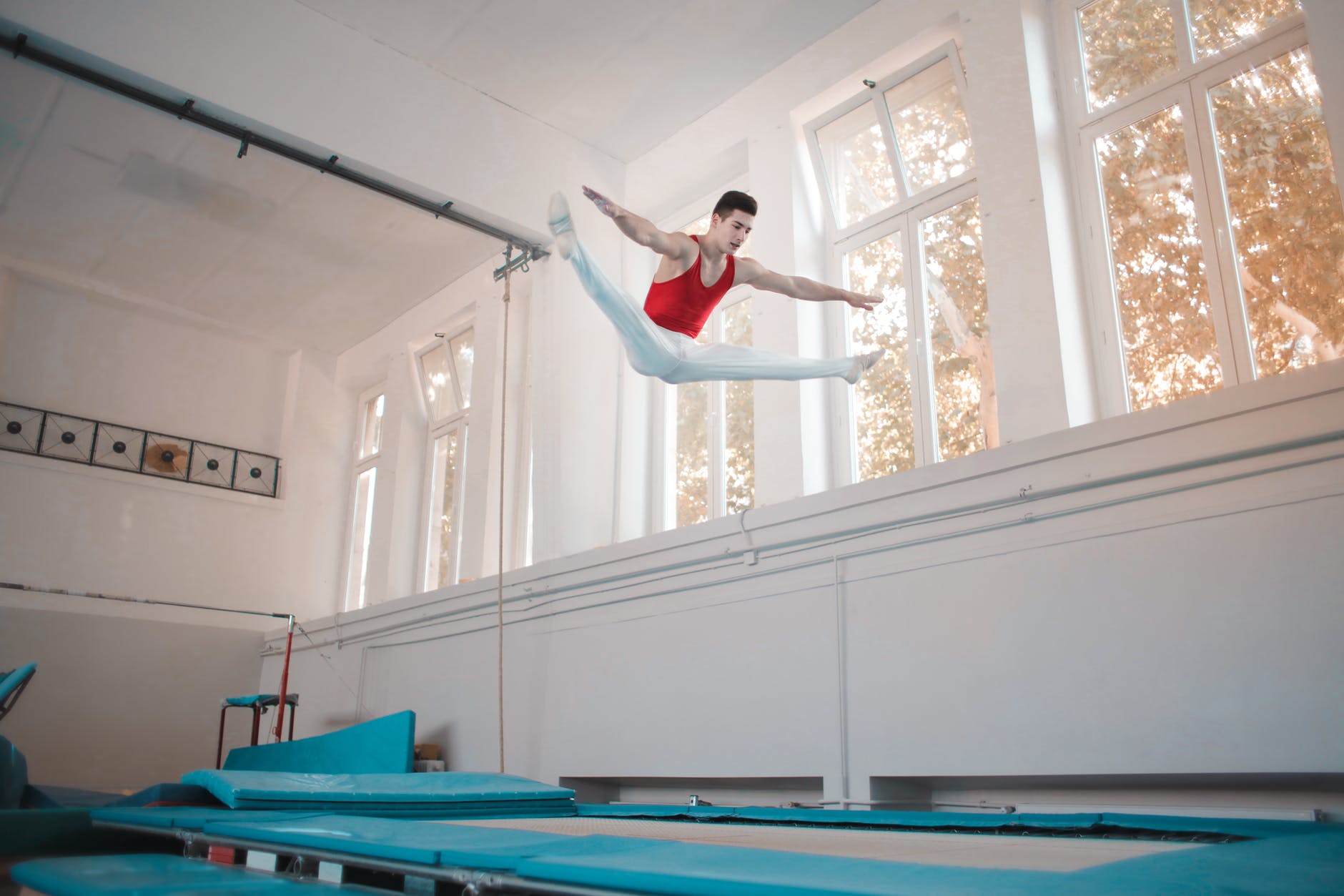 young professional gymnast jumping on trampoline